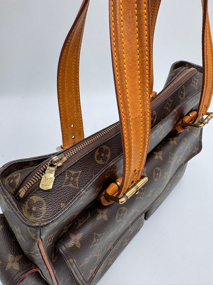 Hardware-Detailansicht der pre-owned Louis Vuitton Multiplicity Cote PVC – glänzend in Szene gesetzt.