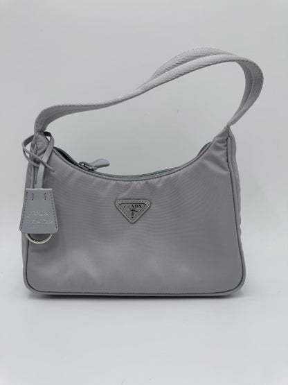 Komplette Ansicht der secondhand Prada Re-Edition 2000 – luxuriöse Pochette-Tasche in blau .
